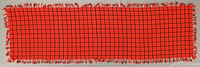 bright red-orange with plaid design in white, green and black; twisted fringe on all four sides. Original from the Minneapolis Institute of Art.