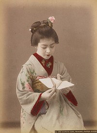 young woman wearing grey kimono with pink and yellow flowers, holding an origami bird made of white paper. Original from the Minneapolis Institute of Art.