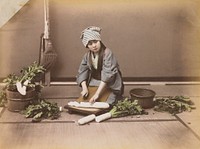 young woman wearing a grey kimono and blue and white striped head scarf, cutting up daikon radishes. Original from the Minneapolis Institute of Art.