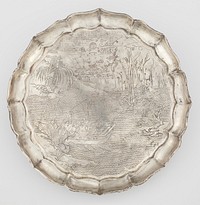 chased silver dish decorated with scene from the "Former Red Cliff Ode" by Su Shi (1037-1101); engraved in painterly baimiao style showing the poet in court robes with two companions relaxing in a boat drifting on tranquil water, with a winepot and cups on the table in front of them; one figure playing a flute and the other holding an open book; rocky banks with grasses and tall reeds, a willow and a cassia tree; small waterfall spilling down from high cliffs at the far shore; sky with pair of birds flying to the left towards a constellation of seven stars drawn as circles joined by thin lines to form the Big Dipper seen through drifting clouds surrounding a full moon engraved with the legendary yu tu dao yaou scene of the Moon Rabbit under the cassia tree pounding a pestle in a mortar; shallow plain sides of octafoil bracket-lobed outline rising to a barbed everted rim. Original from the Minneapolis Institute of Art.