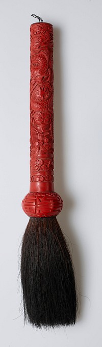 red lacquer handle with spiraling dragon and clouds; stylized good-fortune characters around bulbous section where bristles are attached; doubled black thread on end for hanging loop; dark brown bristles. Original from the Minneapolis Institute of Art.