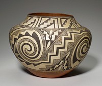 concave foot with sides flaring outward to rounded shoulder; short, inward flaring neck; white body with brown geometric designs; band of designs with stepped triangle motifs on neck; body decorated with two identical designs of pairs of spirals and zigzags separated by vertical strips with squared-off spirals and triangles. Original from the Minneapolis Institute of Art.
