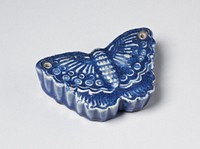 Blue butterfly shaped porcelain water dropper; two small holes, one at the tip of each wing. Original from the Minneapolis Institute of Art.