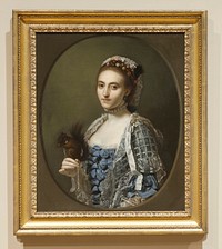 portrait of a young woman wearing a choker of large pearls, a blue dress with bows on the bodice and white lace netting and ribbons over the shoulders, and white lace and tiny pink and yellow flowers in her hair, with a brown squirrel wearing a collar with a silver chain attached, perched on her PR hand; painted oval around image, with grey ground. Original from the Minneapolis Institute of Art.
