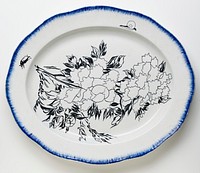 white oval platter with scalloped edge; brushed blue pigment around edge with peonies, a snail and a beetle painted in black. Original from the Minneapolis Institute of Art.