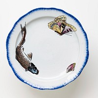 cake plate with white ground and brushed blue pigment around edge of plate and foot with painted carp with blue head, yellow butterfly and a clam on plate surface and a red flower, lavender butterfly and yellow clams on foot. Original from the Minneapolis Institute of Art.