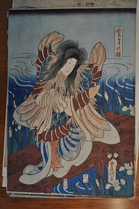 Triptych, with three sheets combining to make a single image; figures on left, center and right; left figure is standing, with large wings on right and let; fringed neckline in pale blue and peach; white flowing sleeves, with under robe with blue, scaly pattern; rippling waves behind figure, who stands on a dock; flowers and long, thin leaves surround dock; center figure has outspread wings in peach and blue pigments; fringed neck piece in g pale blue and peach shades, and sits cross legged on a dock; water in background, with flowers and thin leaves jutting up around dock; tree branch in URC of image that extends into right sheet; right figure stands on land, wearing colorful intricate robes and armor, holding a raised sword in hands; bare outspread feet; tree on right that extends into URC. Original from the Minneapolis Institute of Art.