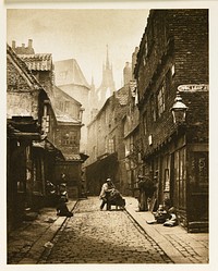 narrow, dark, brick street with tall building on both sides; shadowy castle towers visible in background; women and children standing and seated on sidewalk with man at center seated on wheelbarrow handle, from a portfolio with essay on the photographer. Original from the Minneapolis Institute of Art.