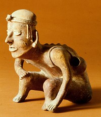 seated male, clay, pigments, West Mexican (Colima), 200 - 700 AD. Figure makes noise when figure is turned over.. Original from the Minneapolis Institute of Art.