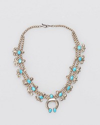 Child's necklace; Double strand of tiny silver beads; twelve cast "cornflowers" on shanks; set with elliptical turquoises; cast naja set with three elliptical Lone Mountain turquoises at apex and terminals J.#476, Cat.#471.. Original from the Minneapolis Institute of Art.