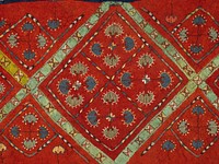 cotton applique; embroidered and applique felt rug; applied braided fringe; finger looped(?) edge; red ground with four diamond patterns across central stripe, each diamond divided into four. Original from the Minneapolis Institute of Art.