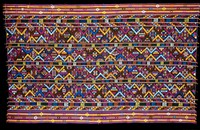 Kira, Oshem; silk/cotton brocade on blue or black cotton background; L.95 in., W.58 in. 3 panels, multicolored discontinuous weft pattern in wool on black cotton background with red, blue, yellow, green stripes at sides; fringe.. Original from the Minneapolis Institute of Art.