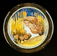 Della Robbia Dish, ceramic, design shows woman's head with garland of wheat, this super-imposed on a wheat-field backgorund, incised design, blue, rose, green, yellow, white glazes, pooter, red clay. Original from the Minneapolis Institute of Art.