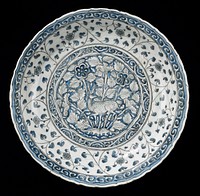 Dish, Meshed ware, Safavid Dynasty, early XVII Century. White earthenware with underglaze blue and black decor. Central medallion reserved in white and painted in outline black on a blue ground with stag leaping in foliate landscape within border of scrolling tendrils.. Original from the Minneapolis Institute of Art.