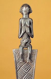 Female figure seated on top of a fan-shaped element decorated with basketweave carvings; small flared area with carved ribs at bottom. Original from the Minneapolis Institute of Art.