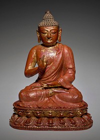 seated figure with legs crossed; PR hand raised in gesture of abhayamudra; wearing robe decorated with patterned block and floral stripes in gold; seated on a lotus petal throne. Original from the Minneapolis Institute of Art.