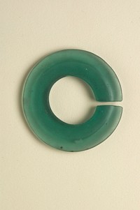 round earring with open center; transparent light green. Original from the Minneapolis Institute of Art.