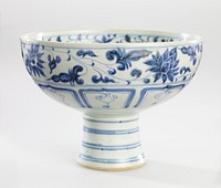 blue and white glaze; bowl on a tall, slightly flaring stem; foliate spray at center; foliate bands on interior and exterior rim with geometric design band below on exterior; blue rings on stem. Original from the Minneapolis Institute of Art.