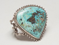 Three square wires; set with large shield-shaped turquoise; teardrop and stamped decoration.; Triple sq. wire with large shield-shaped turquoise, has hole with silver fill cat. 56,J#8. Original from the Minneapolis Institute of Art.