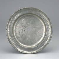 pewter plate with floral and fish motifs in center and Hebrew around outer edge. Original from the Minneapolis Institute of Art.