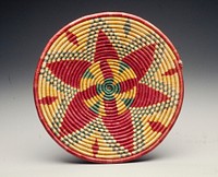 Shallow with foot; central star/flower design and pyramid design on foot in pink, yellow and green dyed fibers. Original from the Minneapolis Institute of Art.