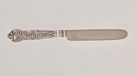 rounded knife blade; 4-pronged fork; each handle has same design on front and back which includes a scallop-shape at the bottom. Original from the Minneapolis Institute of Art.