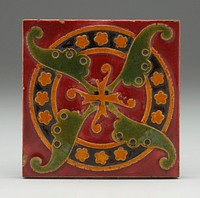 maroon ground; ring in background with brown center, pumpkin edges and filled with pumpkin-colored florettes; four-lobed leaf-like design in green above ring; four-lobed pumpkin-colored design on top. Original from the Minneapolis Institute of Art.