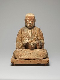 Buddha seated with legs folded and feet over knees; PR hand held in loose fist; PL hand open, gently cradling round object; fragments of white and green pigment; sits on flat base with pigment fragments. Original from the Minneapolis Institute of Art.