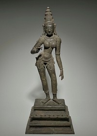 standing female figure with bare breasts, in contraposto pose; wearing tiered conical headdress with wheel on back, necklaces, bracelets, rings, heavy belt, gauzy form-fitting slacks, anklets; figure stands on a graduated base; PL arm down, PR hand upraised. Original from the Minneapolis Institute of Art.