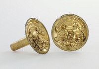 Ear studs, pair, of hammered and engraved gold. The concave disks iwth beaded edges are decorated with an applied motif bearing four figures. Above, a demi-god with elaborate aureole headdress riding on a bar borne by other three figures. In one hand he holds a beaker-cup; in the other a bag adorned with loose bangles. Two of the lower figures wear modified aureole headdresses and carry beakers. All are half human, half beast. The bar on which the demi-god rides is finished at the ends with demon heads. Loose bangles are variously applied in the design. The tubes of the ear studs are decorated with engraved bands of cats and birds, and soldered to the backs of discs.. Original from the Minneapolis Institute of Art.