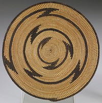 small round mat; tan ground with one radiating zigzag in brown; edged in brown. Original from the Minneapolis Institute of Art.