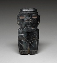 standing figure of green jade; short legs and short arms; frowning expression; wide nose; large incised blank eyes; pierced ears. Original from the Minneapolis Institute of Art.