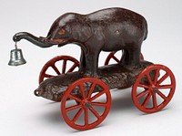 small elephant holding blue bell with its trunk; stands on platform with red wheels. Original from the Minneapolis Institute of Art.