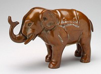 very heavy brass elephant; push tail, trunk moves up. Original from the Minneapolis Institute of Art.