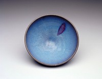 ceramic bowl, small round foot; blue glaze overall with one purple splash at interior side, darker glaze at rim, unglazed foot. Original from the Minneapolis Institute of Art.