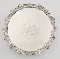 round tray with four metal feet; openwork, outward-flaring rim; central engraving of winged putto with torch, two coats of arms surmounted by two birds and building in background. Original from the Minneapolis Institute of Art.