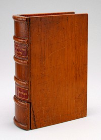 wooden book stained nut brown with labels on spine of red paper with gold lettering: "English and Foreign Bible Society" is the top label; "Thank Offerings" is the bottom label; a drawer at the bottom of the spine slides out; coin slot at top. Original from the Minneapolis Institute of Art.