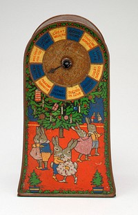 brick shape with rounded top; scenes of rabbits having holiday celebration on front and sides; spinner with wishes for good fortune on front; coin slot in top. Original from the Minneapolis Institute of Art.