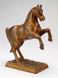 bronze color horse with two front legs off ground; coin slot back of neck; standing on an attached rectangular base. Original from the Minneapolis Institute of Art.