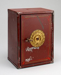 block-shaped dark red bank with gold combo dials on front; red and yellow decorative strips around edge of door; coin slot in back. Original from the Minneapolis Institute of Art.