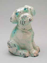 white metal seated dog looking up with floppy ears wearing a collar; he has blue eyes and green primer. Original from the Minneapolis Institute of Art.