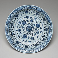 large dish with outward-flaring rim; blue and white; waves around rim; floral design at outer and inner edges and at center. Original from the Minneapolis Institute of Art.