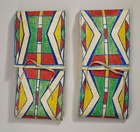 envelope pouch of stiff hide; one tie closure at top center; top decorated with triangle and bar designs in red, blue, yellow and green. Original from the Minneapolis Institute of Art.