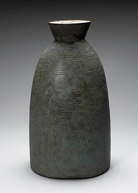 ovoid body, tapering at top with outward-flaring top section; relief design with teardrop shapes, swirls and zigzags; greenish patina. Original from the Minneapolis Institute of Art.