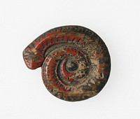 shaped like coiled snake with zigzag decorations; disk at center of coil carved with treelike symbol. Original from the Minneapolis Institute of Art.