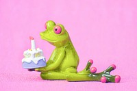 Cute frog holding birthday cake photo