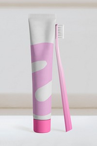 Pink toothpaste tube and toothbrush, oral care product