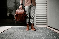 Businessman carrying leather backpack, fashion photo