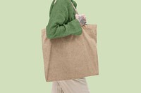 Tattooed woman using tote bag, eco product