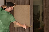 Man put on blank brown paper at a front door